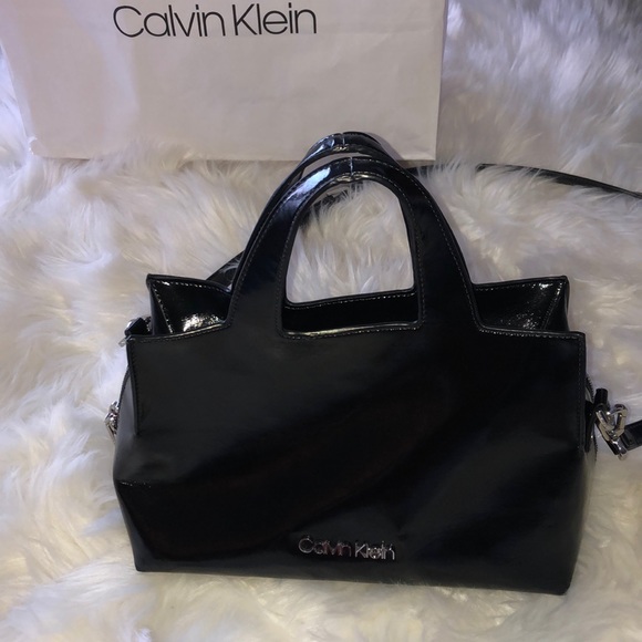 Calvin Klein Handbags - ✨Calvin Klein shiny black purse. Silver zipper. ✨